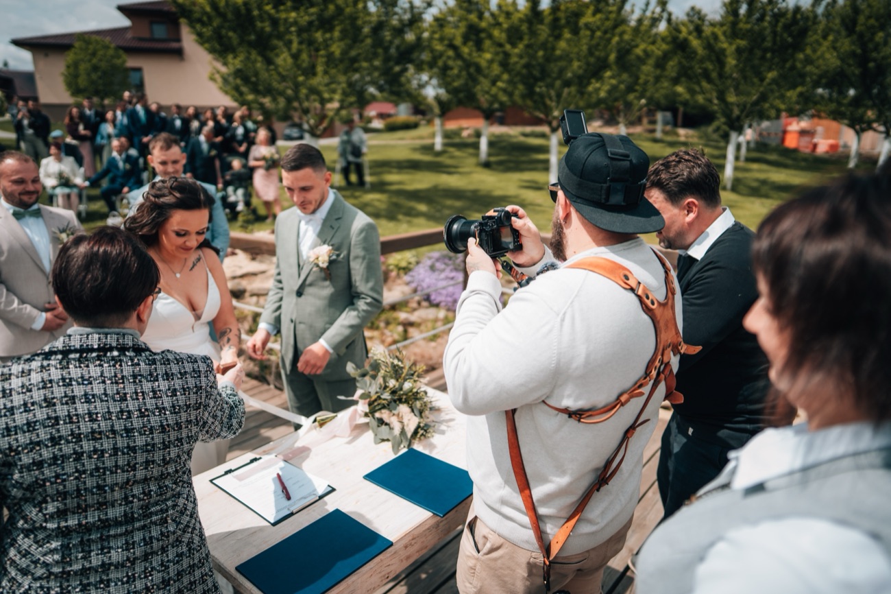 Kenji fotí podpis oddacího listu na svatbě
